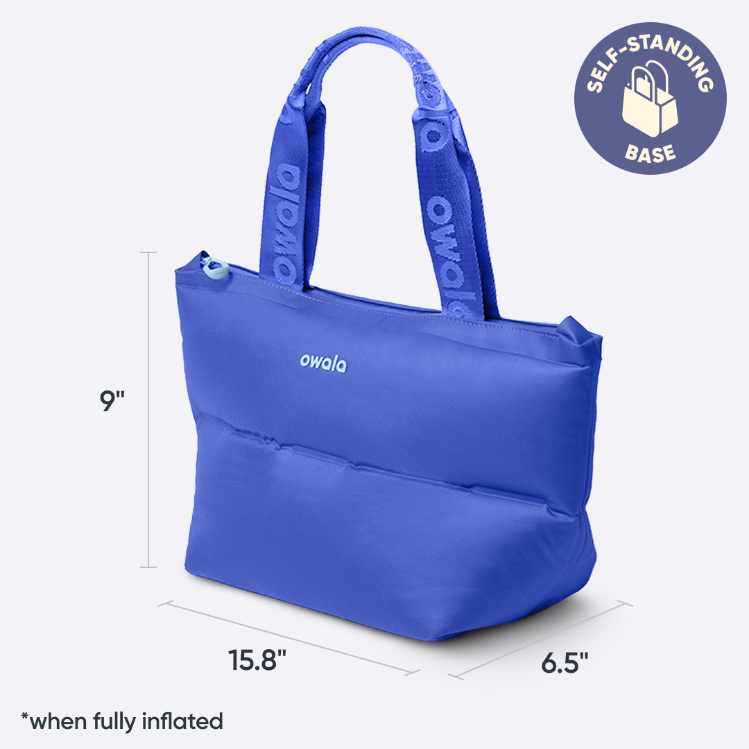Owala Puffer Mini in Al Fresco, cobalt blue puffy tote with matching owala-branded handles, dimensioned at 15.8 inches wide, 6.5 inches deep, and 9 inches tall when fully inflated, with badge reading "SELF-STANDING BASE"