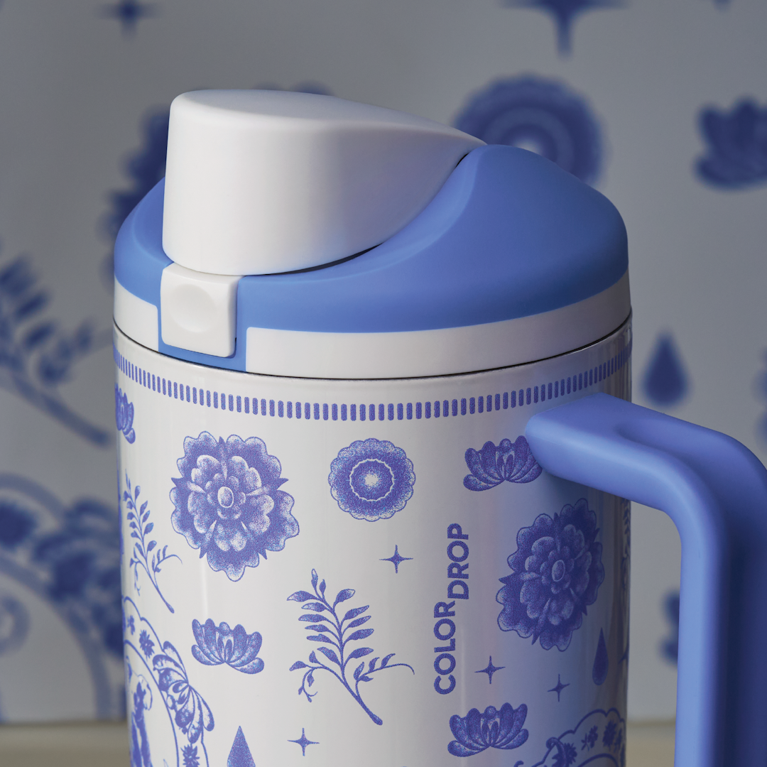 Close-up of the Heirloom FreeSip Tumbler 40oz lavender lid and handle, with the floral print and Color Drop wordmark