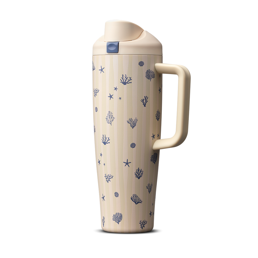 Owala FreeSip Tumbler 30oz in Coral Cabana, cream insulated stainless steel body with navy coral, starfish, and seashell pattern, matching cream flip cap, lid, and side handle with navy push-button