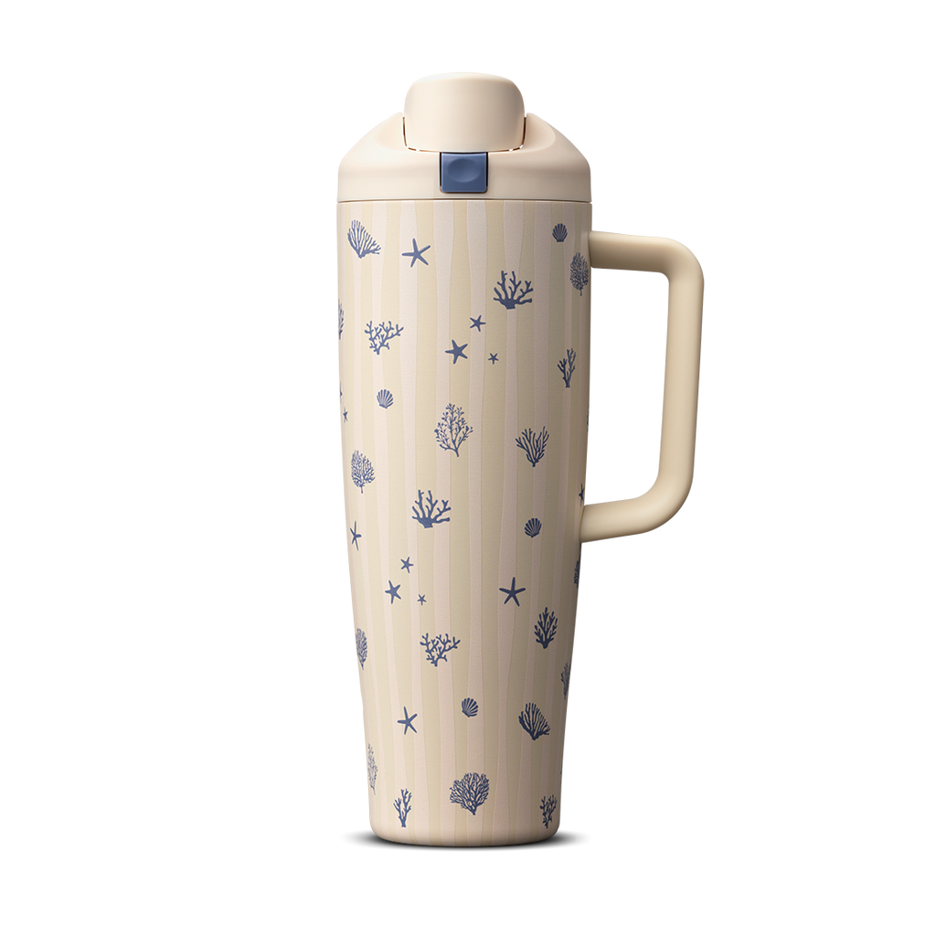 Owala FreeSip Tumbler 30oz in Coral Cabana, cream insulated stainless steel body with navy coral and seashell pattern over vertical stripes, cream flip cap and side handle