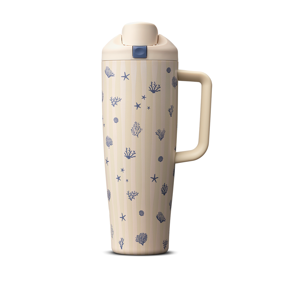 Owala FreeSip Tumbler 30oz in Coral Cabana, cream insulated stainless steel body with navy coral and seashell pattern over vertical stripes, cream flip cap and side handle