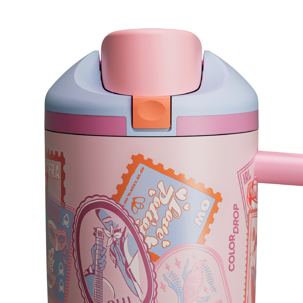 Owala FreeSip Tumbler in Sending Love, lid detail showing pink flip cap, pink push-button, and orange accent over postage-stamp-and-heart patterned body