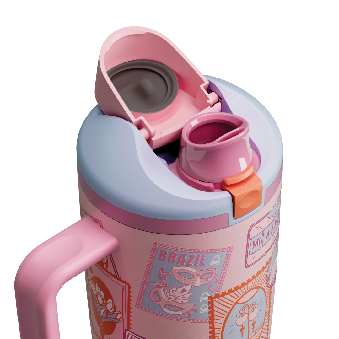 Owala FreeSip Tumbler in Sending Love, pink flip cap open exposing pink FreeSip spout with orange accent over patterned body and pink side handle