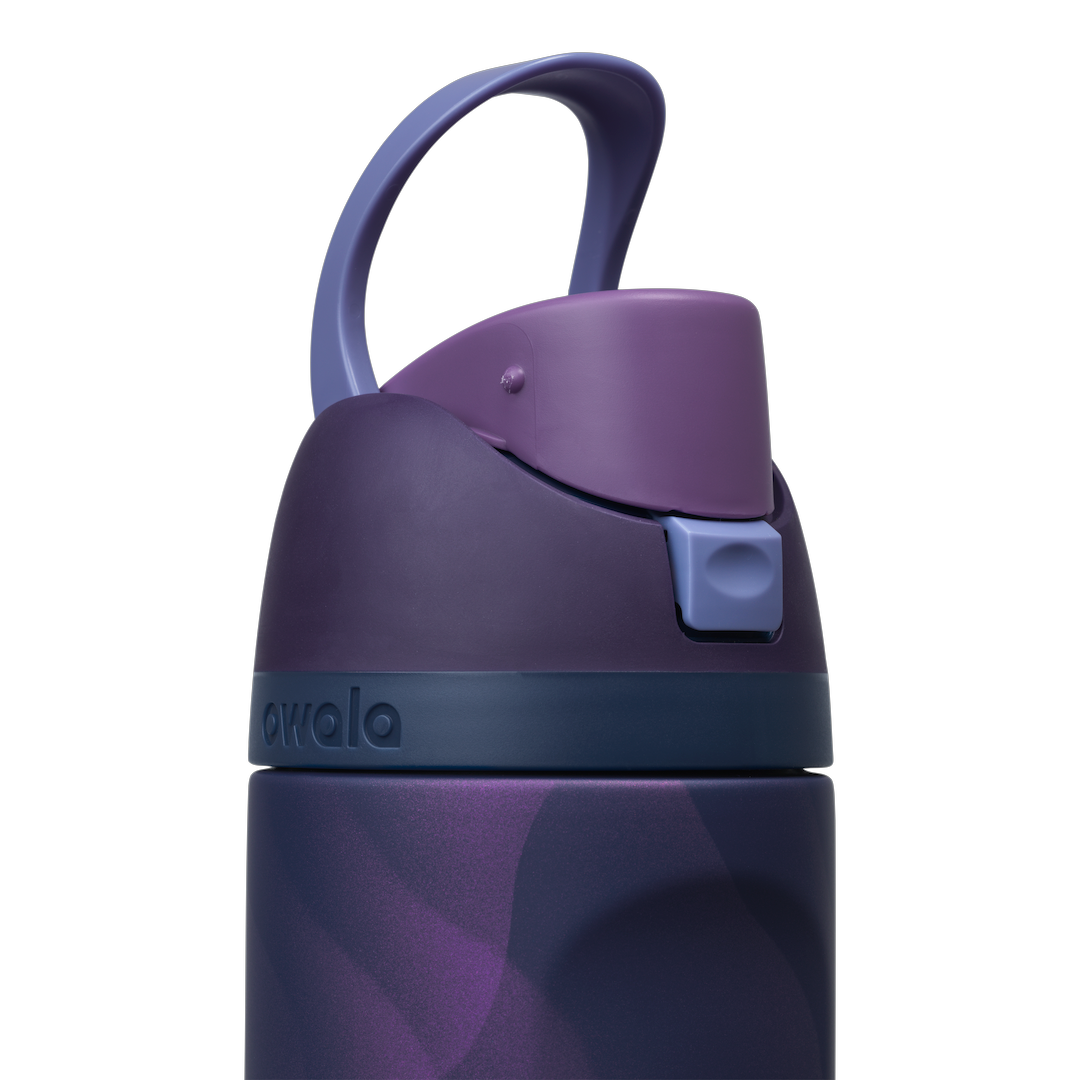 Owala FreeSip 24oz in Arctic Storm, close-up of the deep purple flip cap with periwinkle carry loop raised and the navy accent band at the lid base