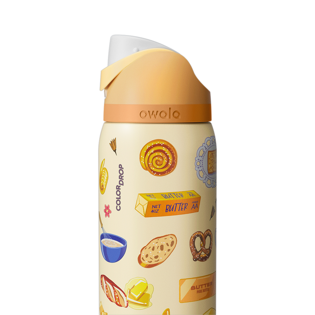 Owala FreeSip 32oz in Brunch Bunch, close-up of the cream patterned body with Color Drop wordmark and peach flip cap with cream carry loop