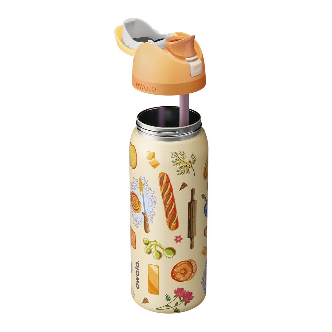 Owala FreeSip 32oz in Brunch Bunch, exploded view showing the cream patterned body, peach lid with cream carry loop, and pink silicone straw