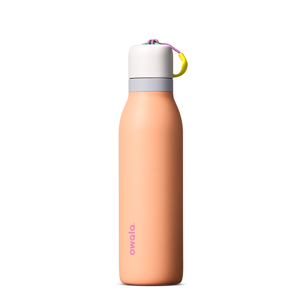 FreeSip Twist 24oz in Peachy Keen (soft coral-peach) with a light grey lid and multicolor loop accent, shown