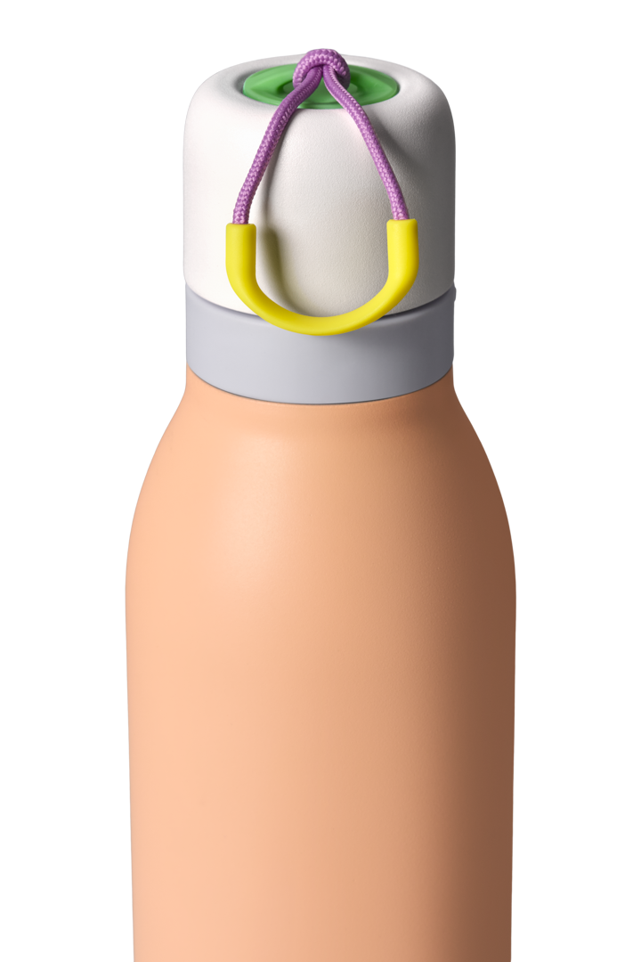 Owala FreeSip Twist 24oz in Peachy Keen, close-up of twist cap and carry string showing peach body, white twist cap with gray accent band, purple carry string, and yellow carry string grip