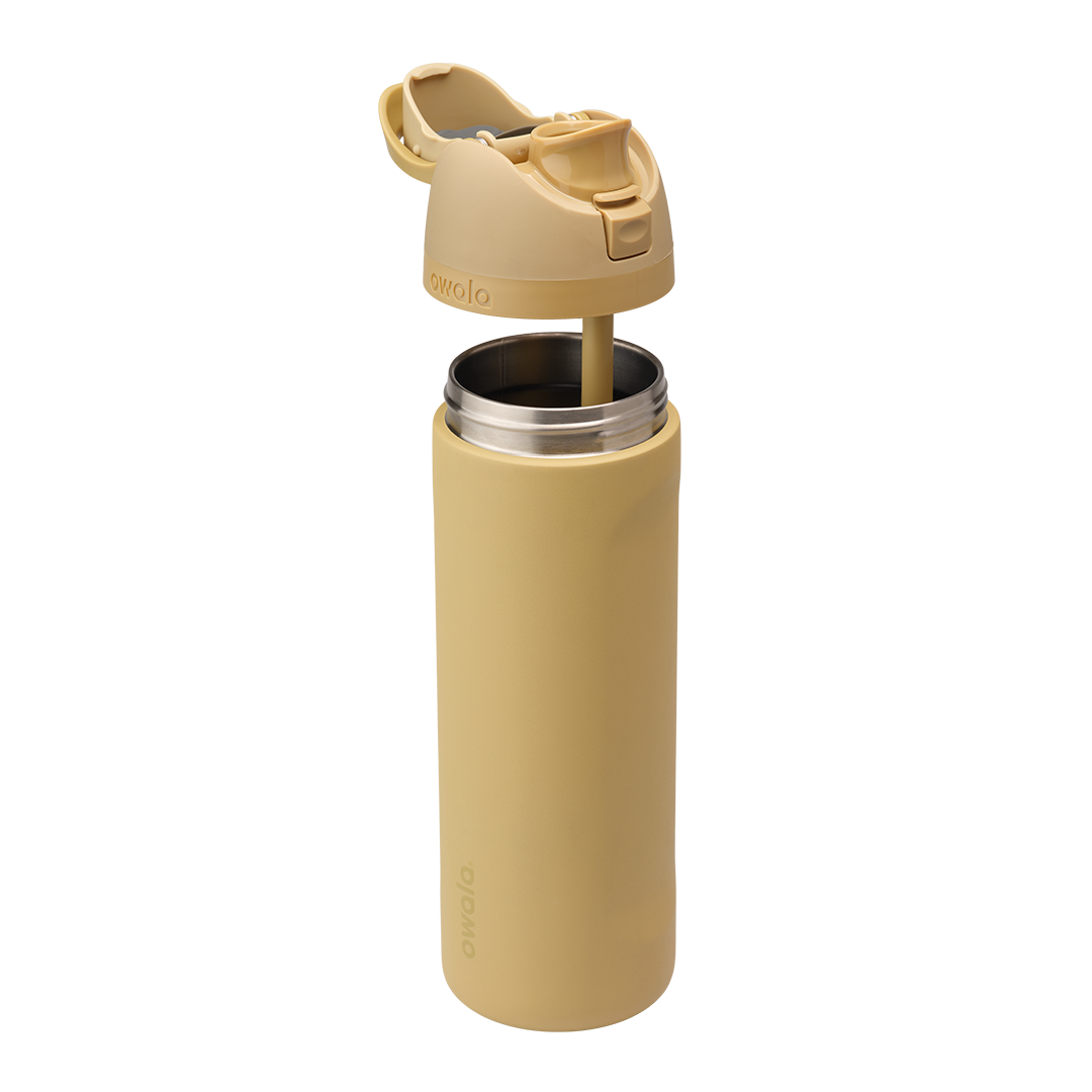 Owala FreeSip 24oz in Autumn Vista, exploded view showing warm honey-sand insulated stainless steel body separated from matching flip cap with carry loop