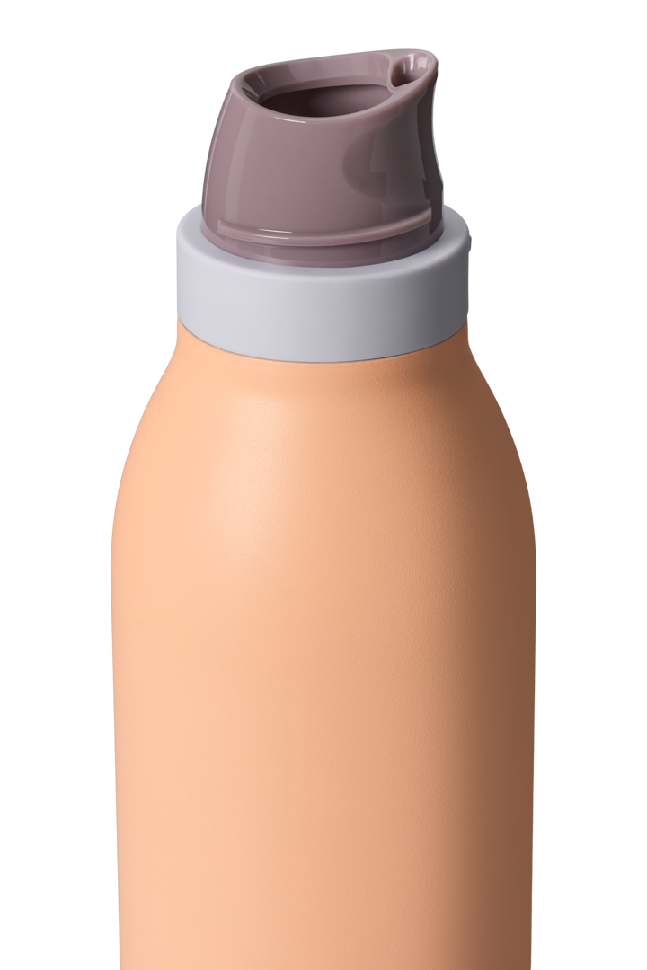 Owala FreeSip Twist 24oz in Peachy Keen, close-up of lid area with twist cap removed showing mauve FreeSip spout, peach body and gray accent band