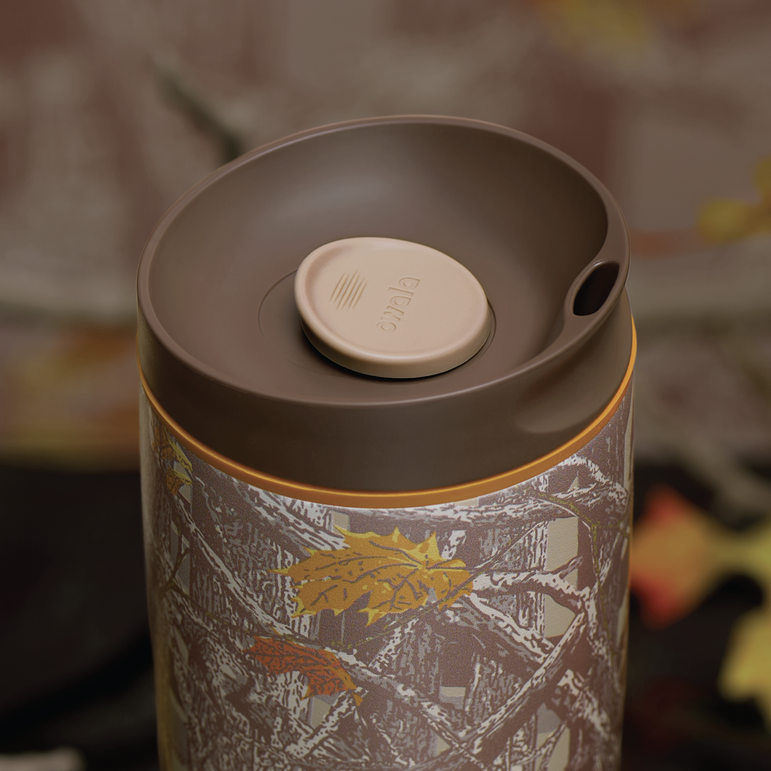 Owala SmoothSip Slider in Out of Sight, lid detail showing brown flip cap with cream push-button and orange accent over woodland camo patterned body
