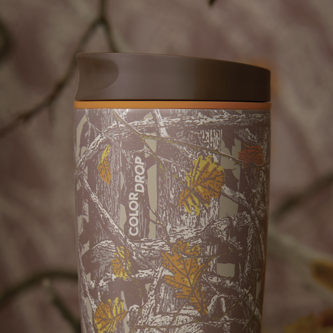 Owala SmoothSip Slider in Out of Sight, woodland camo patterned body with orange lid accent ring and brown flip cap, COLOR DROP text visible on body
