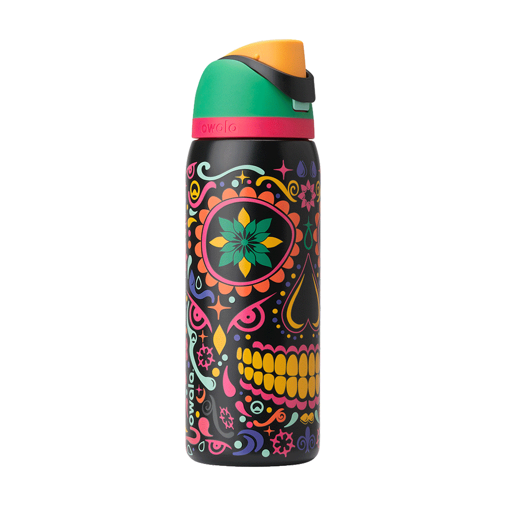 Owala FreeSip Sway 32oz in Sugar Skull, exploded view showing black body with sugar-skull pattern, green flip cap with pink accent ring, orange push-button, and red straw lifted above; glows in the dark